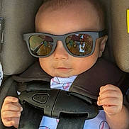 Asaiah joined the competition — help win amazing prizes! baby, child, sunglasses, car_seat, harness, baseball_print, onesie, infant, seatbelt, reflection, cool, cute, hands, casual, portrait, indoors, fashion, headwear, person, young
