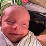 Asaiah is registered to the contest to win money with this photo: baby, newborn, infant, smile, face, wrapped, blanket, striped, closeup, skin, head, sleepy, cute, child, person, portrait, indoors, soft, warm, cozy