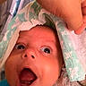Asaiah joined the competition — help win amazing prizes! baby, infant, face, mouth_open, wide_eyes, hand, cloth, patterned_fabric, curious, surprised, blue_clothing, skin, closeup, expression, newborn, soft_texture, blanket, indoor, person, child