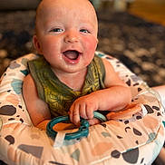 Oliver joined the competition — help win amazing prizes! accessories, baby, babylaughing, bodypart, clothing, cushion, dress, face, happy, head, homedecor, laughing, mouth, newborn, person, photography, portrait, scissors, smile, strap