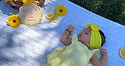 Charlotte is registered to the contest to win money with this photo: baby, infant, yellow_dress, headband, blanket, outdoor, grass, flowers, basket, lemons, sign, two_months, sleeping, nature, sunlight, summer, cute, peaceful, portrait, resting