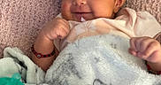 Charlotte is registered to the contest to win money with this photo: baby, blanket, bow, bracelet, child, cozy, cushion, cute, face, happy, headband, indoors, infant, lying_down, pacifier, person, portrait, sleepwear, smiling, soft