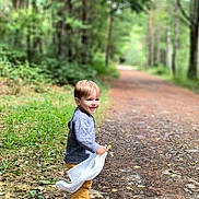 Louka Seguet participe au concours pour gagner de l'argent avec cette photo : casual, child, clothing, daylight, dirt_path, forest, greenery, happy, leaves, nature, outdoor, path, playful, smiling, sneakers, toddler, trees, walking, white_cloth, young_child