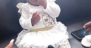 D'Aruia joined the competition — help win amazing prizes! baby, black_leather, bow, child, couch, curious, cute, fingers, footwear, hand, indoor, infant, patterned_pants, portrait, sitting, smartphone, support, tutu, white_clothing, young_child
