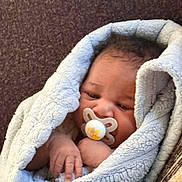 Amuri Gaddy joined the competition — help win amazing prizes! baby, blanket, child, closeup, comfort, cozy, cute, face, hand, indoors, infant, newborn, pacifier, portrait, relaxed, resting, sleepy, soft_texture, warm, wrapped