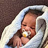 baby, blanket, child, closeup, comfort, cozy, cute, face, hand, indoors, infant, newborn, pacifier, portrait, relaxed, resting, sleepy, soft_texture, warm, wrapped