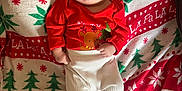 Malakai joined the competition — help win amazing prizes! baby, blanket, carpet, child, christmas_blanket, couch, cozy, cute, face, festive, happy, holiday_theme, indoor, infant, person, red_clothing, santa, smile, socks, white_pants