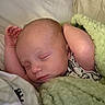 Josef is registered to the contest to win money with this photo: newborn, baby, sleeping, portrait, face, closed_eyes, arms_up, blanket, plush_toy, green, bed, bedding, cozy, indoors, infant, peaceful, resting, soft_texture, photography, watermark