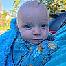 Josef is registered to the contest to win money with this photo: baby, blanket, blue_blanket, blue_eyes, bug_pattern, car, child, close_up, clothing, eyes, face, family_photo, infant, insect_pattern, looking_at_camera, outdoor, portrait, serious_expression, sitting, sunlight