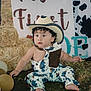 Liam joined the competition — help win amazing prizes! toddler, child, cowboy_hat, overalls, balloons, hay_bale, grass, outdoor, costume, curly_hair, cute, portrait, sitting, cow_print, decor, baby, one_year_old, fashion, playful, event