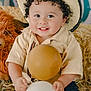 Liam joined the competition — help win amazing prizes! toddler, child, cowboy_hat, curly_hair, balloon, yellow_balloon, white_balloon, plush_toy, lion_toy, hay, beige_shirt, blue_jeans, smiling, outdoor, cute, portrait, happy, playful, baby, hands