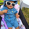 Mycaha is registered to the contest to win money with this photo: accessory, baby, casual, child, cute, denim, fashion, grass, hat, infant, outdoor, person, pink, portrait, relaxing, seat, stroller, summer, sunglasses, sunny