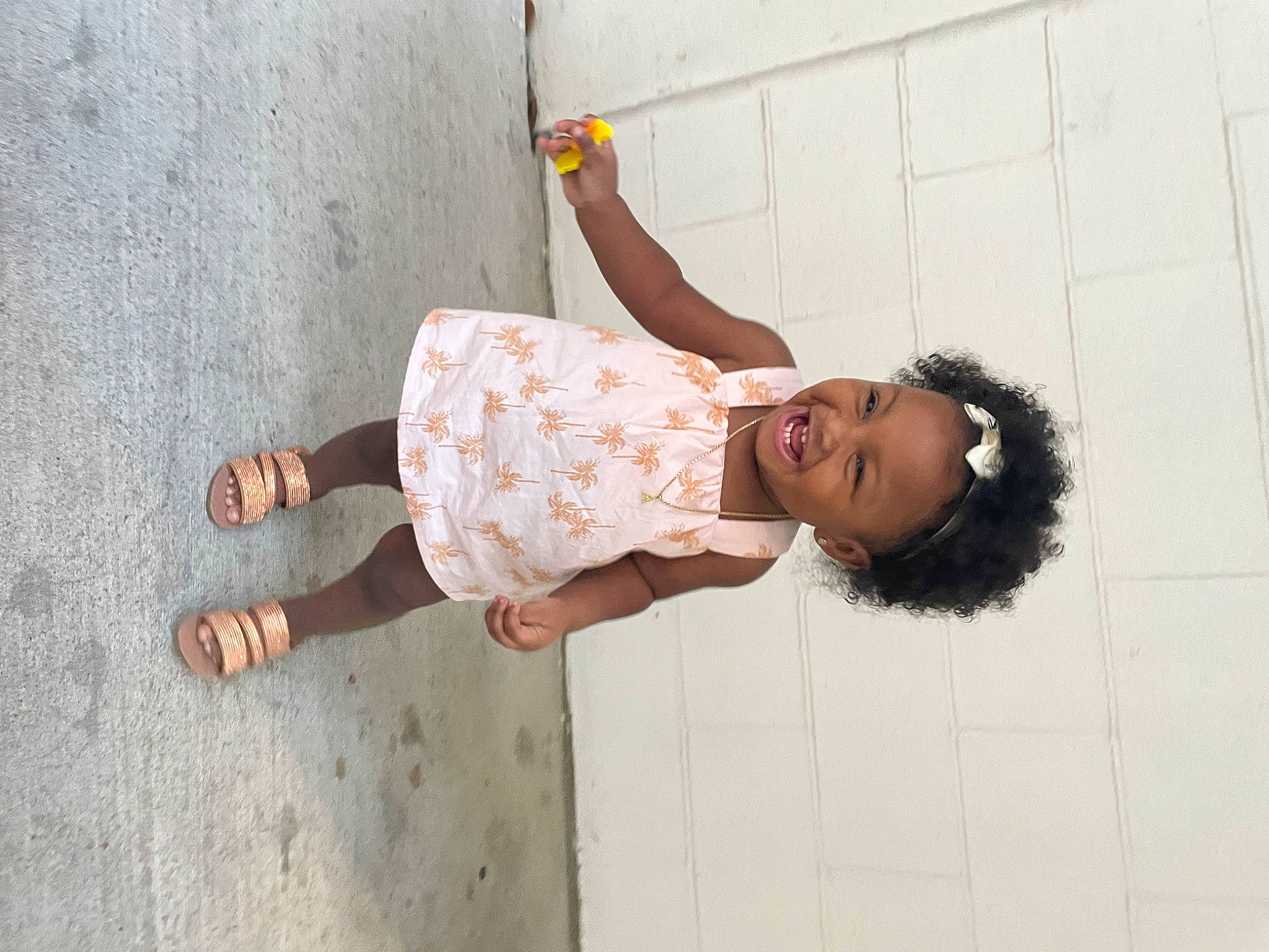 Aarian is registered to the contest to win money with this photo: elbow, finger, foot, fun, happy, human_body, human_leg, joint, joy, knee, leg, leisure, pattern, person, sandal, skin, sleeve, street_fashion, thigh, toddler