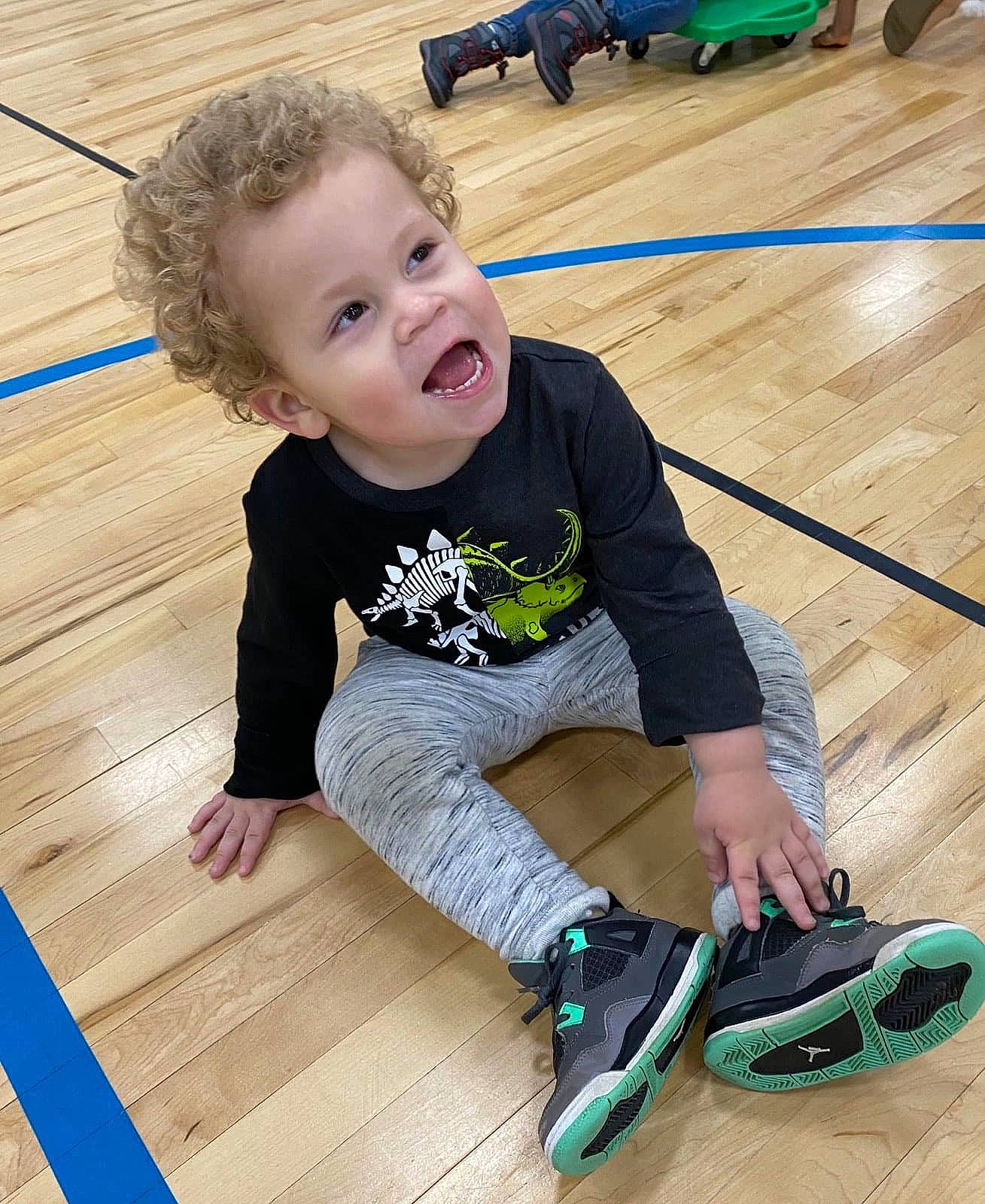 Santana joined the competition — help win amazing prizes! baby_toddler_clothing, black, blue, floor, flooring, happy, hardwood, joint, knee, laminate_flooring, leg, person, sleeve, smile, sneakers, t_shirt, toddler, walking_shoe, wood, wood_stain
