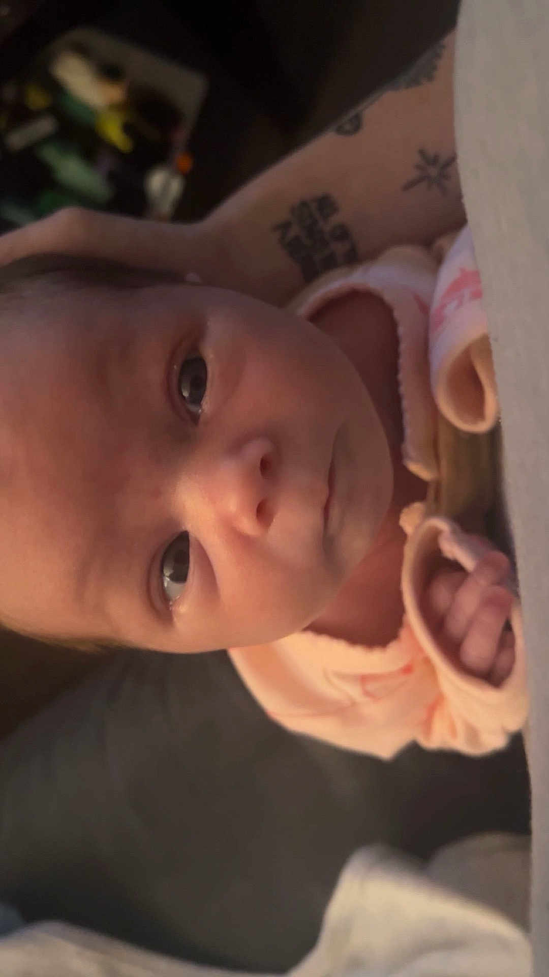 Andi is registered to the contest to win money with this photo: baby, newborn, infant, face, hand, tattoo, skin, person, portrait, closeup, soft_lighting, human, cute, clothing, sleeve, parent, holding, indoor, young, newborn_baby