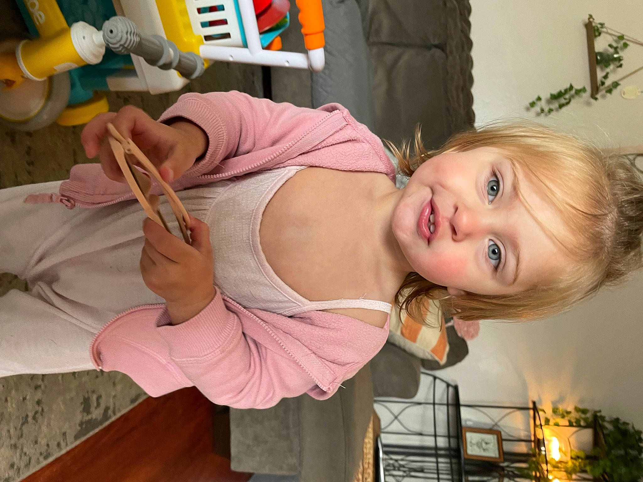 Josie is registered to the contest to win money with this photo: abdomen, chest, child, eyelash, fun, happy, hat, mouth, person, plant, room, sitting, smile, tableware, toddler, vacation