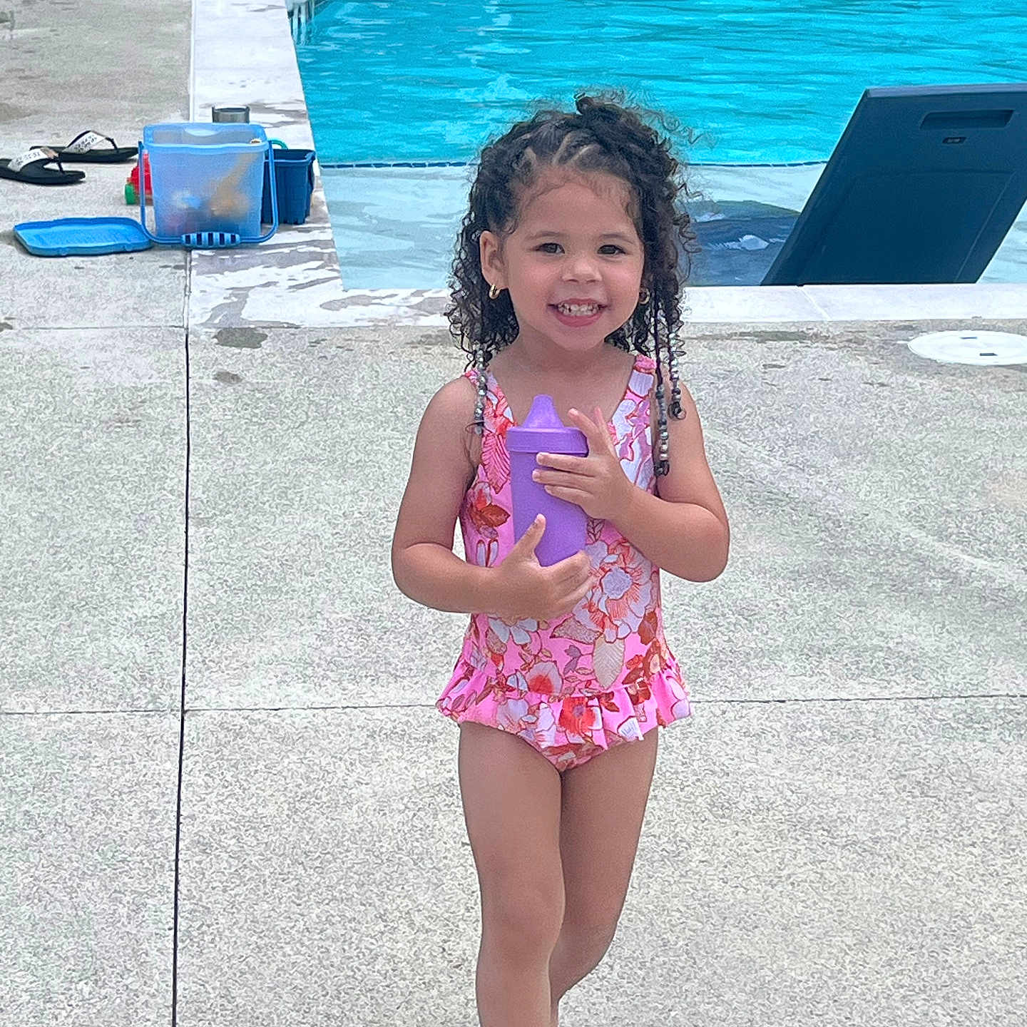 Saroya is registered to the contest to win money with this photo: child, clothing, electronics, face, female, footwear, girl, hair, head, person, phone, photography, pool, portrait, shoe, shorts, summer, swimmingpool, swimwear, water