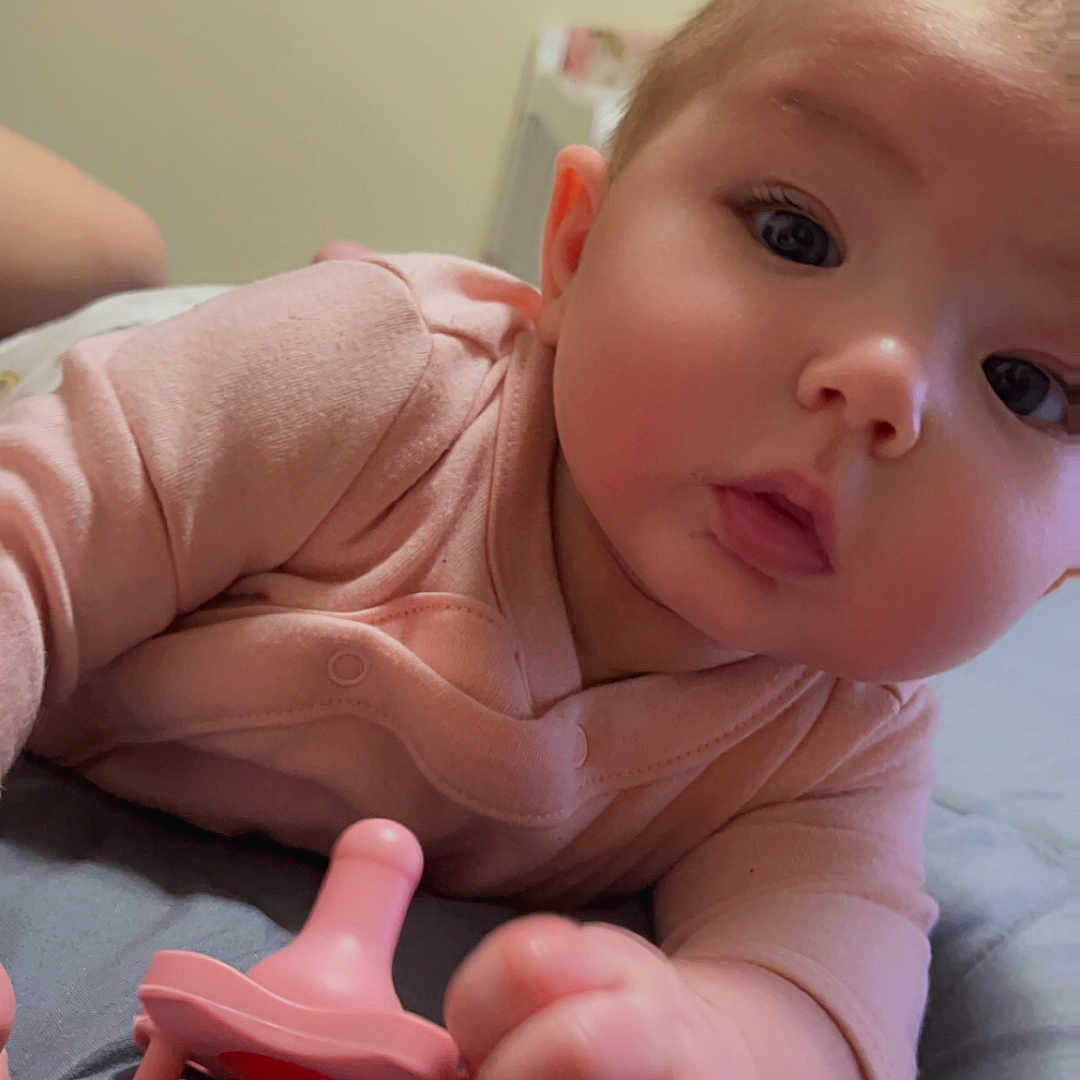 Harleigh joined the competition — help win amazing prizes! accessories, baby, bed, bedroom, bodypart, clothing, couch, face, finger, furniture, hand, head, indoors, newborn, person, photography, portrait, room, t_shirt, toy