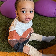Noah Ryan participe au concours pour gagner de l'argent avec cette photo : toddler, child, sitting, sweater, knitwear, grey_socks, green_rug, wooden_floor, purple_cushions, indoor, curious_expression, young_child, flooring, playroom, cozy, portrait, casual_clothing, small_hands, big_eyes, cute
