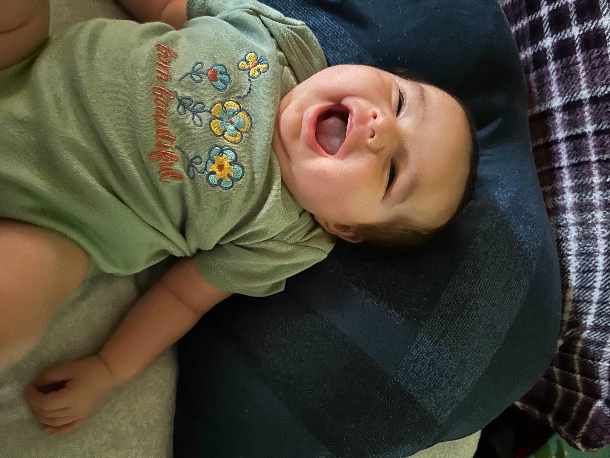 Adaline is registered to the contest to win money with this photo: baby, baby_products, baby_toddler_clothing, cheek, child, comfort, elbow, fun, grass, happy, linens, mouth, nose, pattern, person, sitting, skin, sleeve, smile, tartan