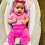 Kayla is registered to the contest to win money with this photo: baby, infant, pink_clothing, headband, smiling, baby_seat, floral_pattern, cushion, indoors, carpet, cute, happy, person, child, young, comfortable, portrait, sitting, apparel, footwear_absent