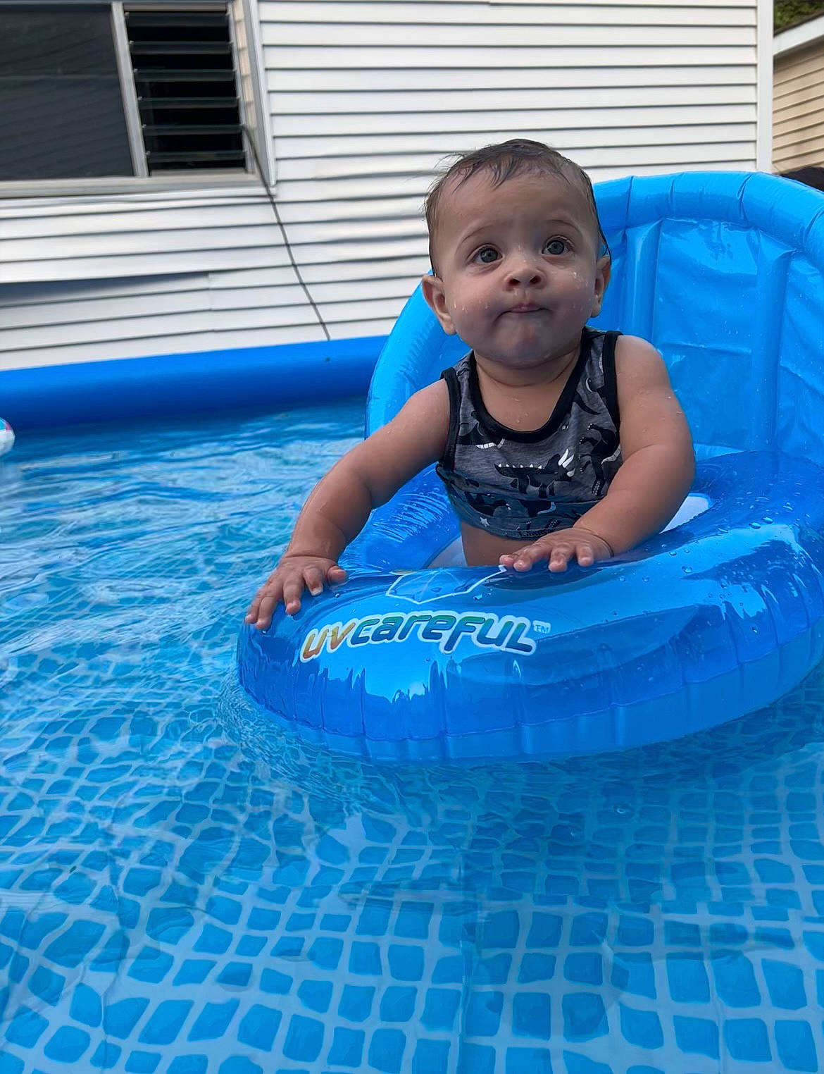 Xaviel is registered to the contest to win money with this photo: azure, baby, baby_products, baby_toddler_clothing, bathing, blue, child, composite_material, electric_blue, face, fun, happy, inflatable, leisure, person, recreation, smile, swimming_pool, toddler, water