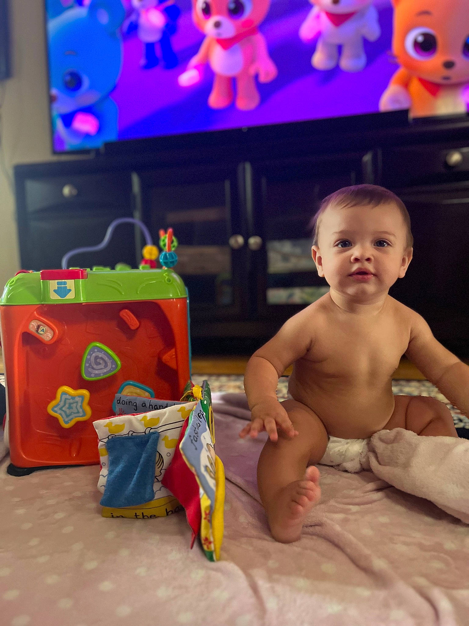 Xaviel is registered to the contest to win money with this photo: animated_cartoon, art, baby, blue, chest, child, event, flooring, foot, fun, mammal, organ, person, photograph, play, product, room, snapshot, stuffed_toy, toddler