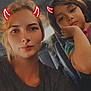 Zoey-Ann joined the competition — help win amazing prizes! car, casual_clothing, child, colorful_shirt, devil_horns_filter, expression, face, filter, hair, head, indoor, people, portrait, red_horns, seat, seatbelt, sitting, tie_dye, woman, young