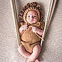 baby, infant, knitted, lion_costume, hammock, beige, soft_texture, cute, portrait, wide_eyes, baby_clothing, hand_knitted, cozy, comfortable, newborn, child, resting, fabric, background, baby_pose