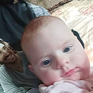 Roselynn joined the competition — help win amazing prizes! baby, infant, child, close_up, selfie, portrait, indoor, couch, blanket, drool, pink_clothing, eyes, mouth, adult_torso, printed_tshirt, hair, necklace, wall_art, pillow, relaxed