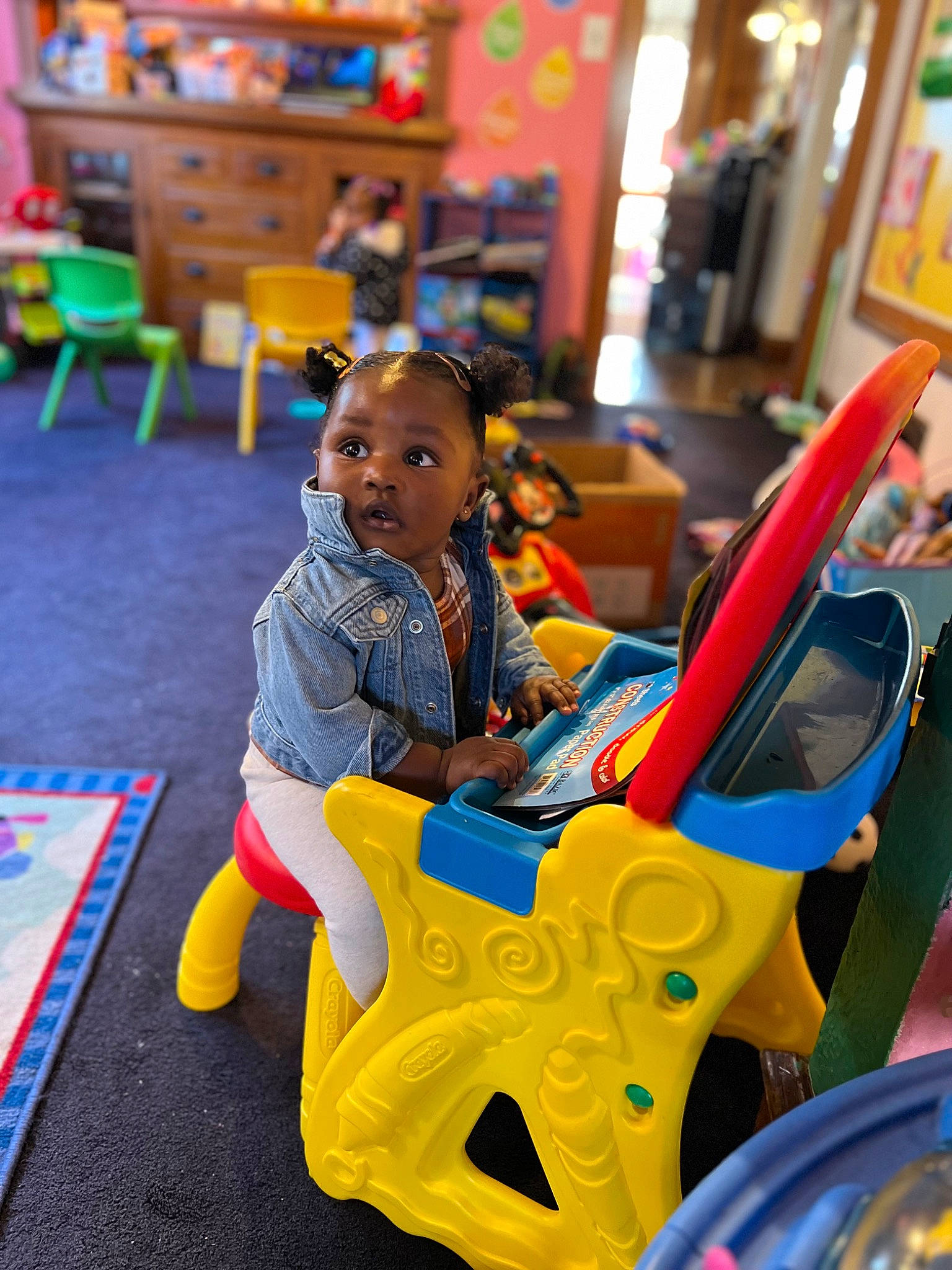 Kenzie is registered to the contest to win money with this photo: amusement_ride, chair, child, city, event, flooring, fun, happy, kindergarten, leisure, nonbuilding_structure, person, photograph, plastic, play, recreation, room, sitting, snapshot, toddler
