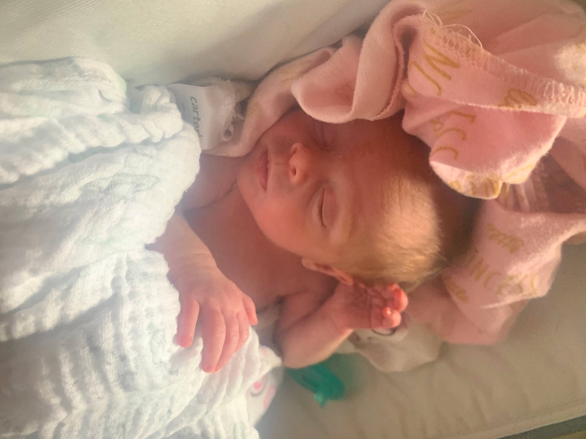 Charlotte is registered to the contest to win money with this photo: arm, baby, bed, bedding, cheek, child, comfort, ear, finger, gesture, happy, linens, mammal, mouth, nose, person, pink, skin, textile, thumb