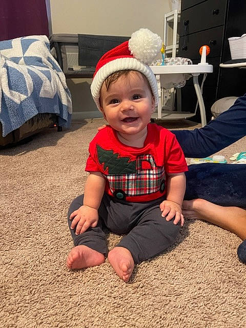 Bilal is registered to the contest to win money with this photo: baby, baby_toddler_clothing, barefoot, cap, carmine, child, flooring, foot, fun, grass, happy, hat, joy, pattern, person, room, sitting, sleeve, smile, standing