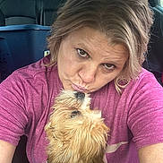Charlie Leo Hopper is registered to the contest to win money with this photo: woman, dog, car, pet, affection, cute, fluffy_dog, casual_clothing, indoor, portrait, love, human, animal, seat, seatbelt, hairstyle, closeup, interaction, expression, transportation