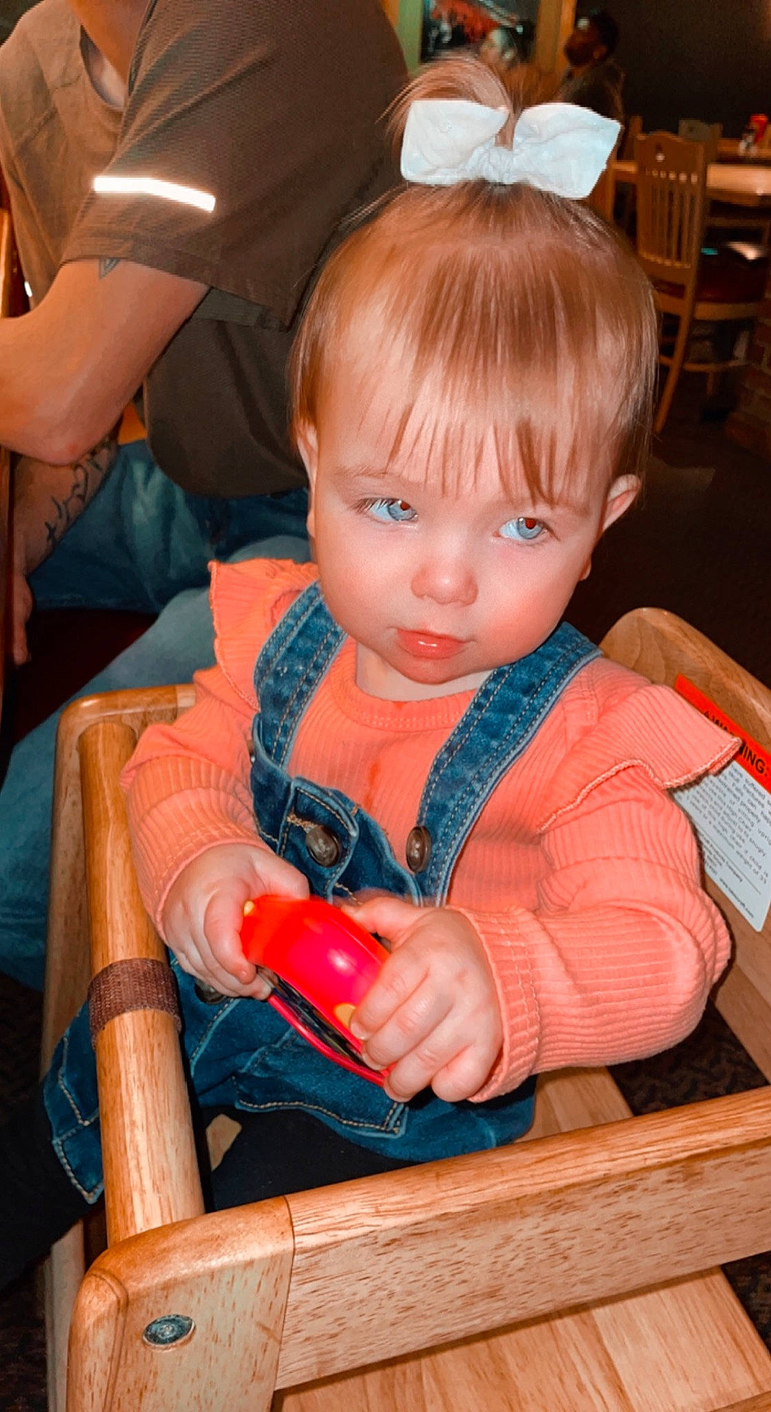 Isla is registered to the contest to win money with this photo: baby_toddler_clothing, bangs, brown_hair, chair, cheek, child, fashion_accessory, fun, head, hime_cut, iris, organ, person, play, room, sitting, skin, toddler, toy, varnish