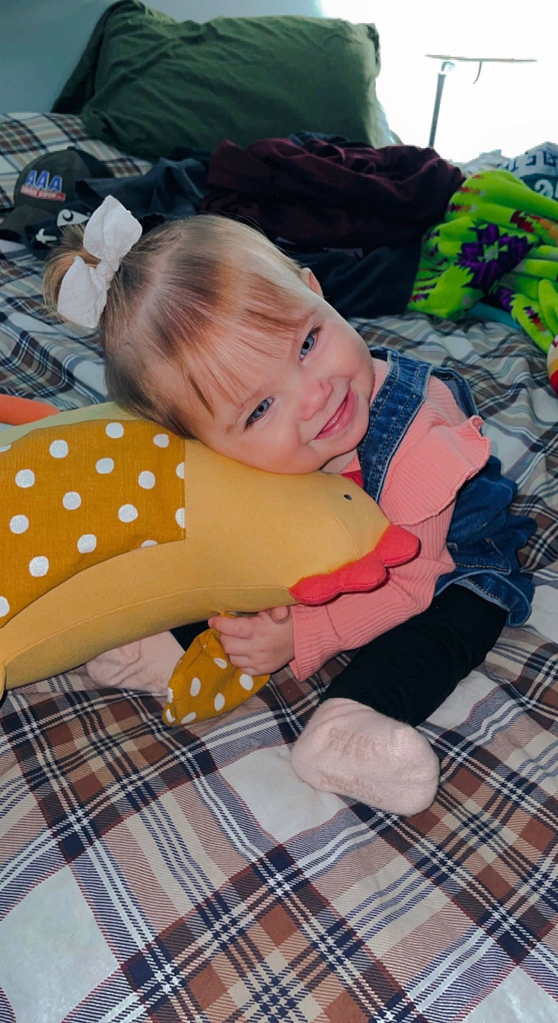 Isla joined the competition — help win amazing prizes! abdomen, child, comfort, finger, flooring, fun, grass, green, happy, human_leg, joy, lap, leisure, linens, pattern, person, plaid, smile, tartan, textile