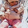 baby, child, hat, pom_pom, jacket, pink_pants, infant, face, eyes, outdoor, sunlight, seat, patterned, warm_clothing, cute, portrait, cozy, hands, feet, winter_wear