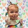 baby, child, smiling, pigtails, activity_center, colorful, heart_pattern, cute, infant, playful, portrait, indoors, happy, young_child, face, clothing, toy, closeup, cheerful, person