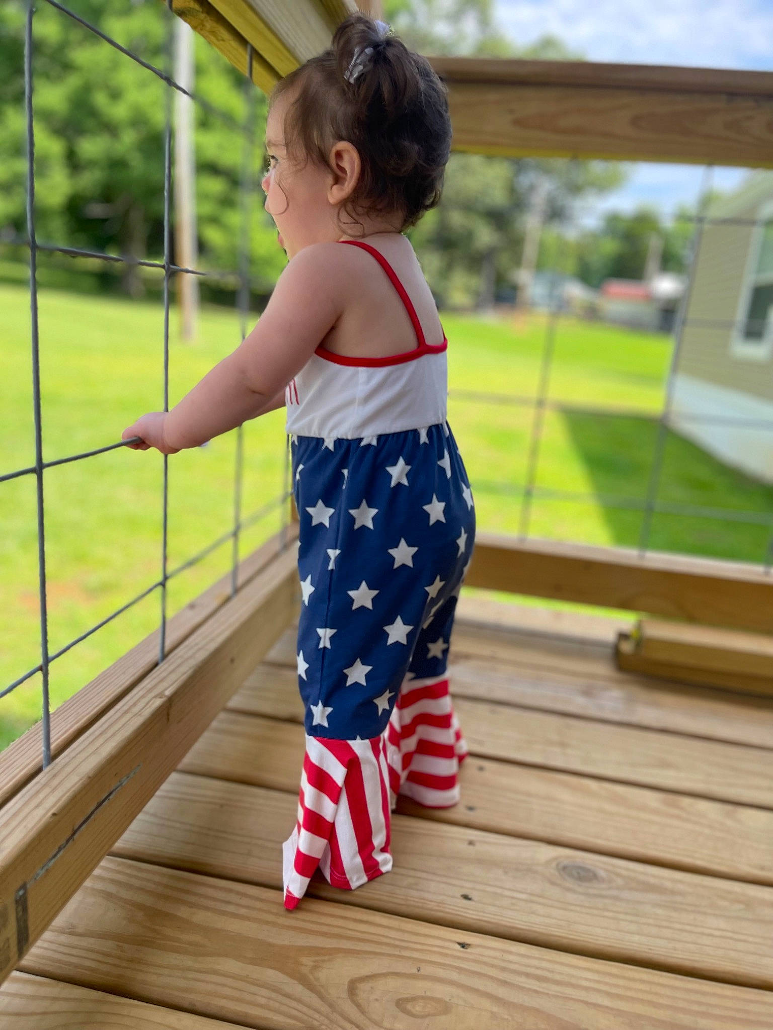 Kyndall is registered to the contest to win money with this photo: baby, baby_toddler_clothing, child, city, electric_blue, flag_of_the_united_states, fun, grass, human_leg, knee, leisure, pattern, person, recreation, sleeve, t_shirt, thigh, toddler, tree, waist