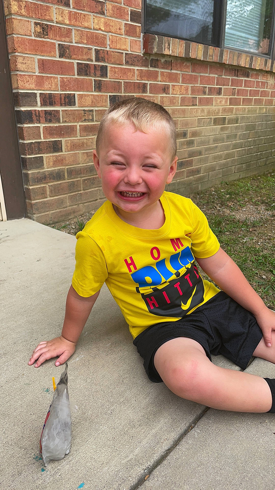 Easton is registered to the contest to win money with this photo: baby, baby_toddler_clothing, bird, brick, brickwork, child, eye, flooring, fun, grass, happy, human_leg, joy, mammal, mouth, person, smile, standing, t_shirt, thigh