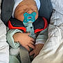 baby, infant, pacifier, car_seat, blanket, hat, sleeping, child, clothing, safety_belt, newborn, cute, cozy, resting, indoors, soft, warm, comfort, face, hand