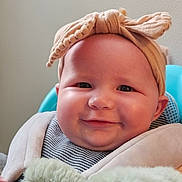 Amelia joined the competition — help win amazing prizes! baby, child, smiling, headband, bow, teddy_bear, plush_toy, cute, portrait, indoor, soft_toy, happy, infant, seated, clothing, striped_shirt, furniture, baby_carrier, face, closeup