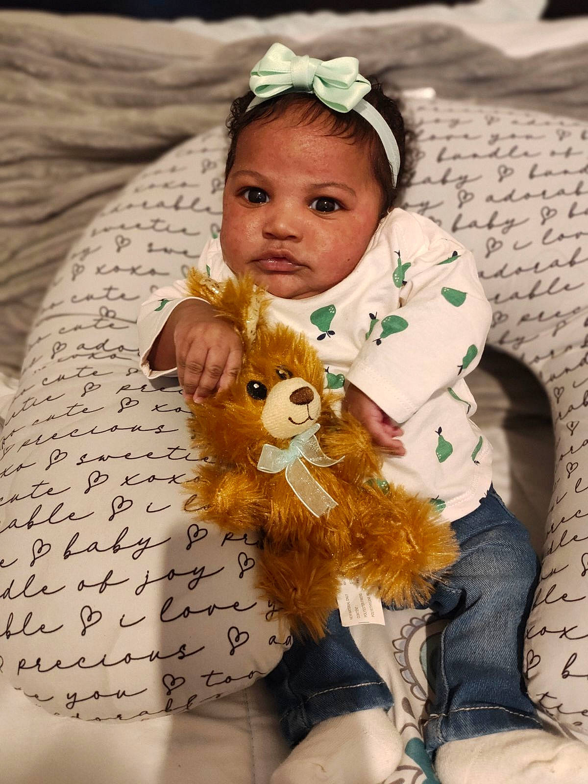 Nylee is registered to the contest to win money with this photo: baby, brown_hair, child, doll, eye, fashion_accessory, fawn, fictional_character, fur, hair, handwriting, happy, head, headband, headpiece, pattern, person, petal, toddler, toy