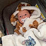 baby, pacifier, blanket, stroller, hooded_outfit, fur_texture, cartoon_character, sleepy_face, cozy, child, infant, cute, soft, warm, outdoor, bundle, clothing, portrait, face, babywear