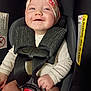 baby, child, car_seat, headband, smile, drool, safety_harness, infant, clothing, cute, happy, person, seatbelt, closeup, indoor, skin, face, hand, sitting, toddler