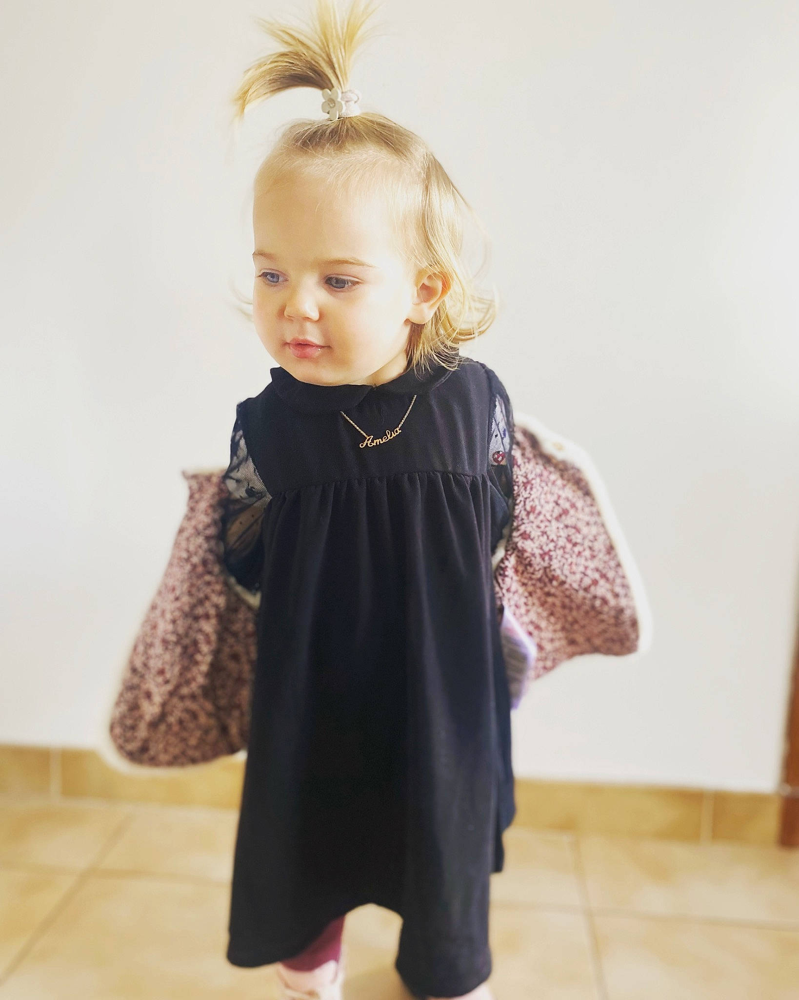 Amelia participe au concours pour gagner de l'argent avec cette photo : arm, baby_toddler_clothing, blond, child, clothing, day_dress, eyelash, fashion_design, flooring, formal_wear, joint, leg, neck, one_piece_garment, pattern, person, shoulder, sleeve, standing, toddler