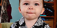 Arrow joined the competition — help win amazing prizes! toddler, child, portrait, indoor, shirt, black_and_white, floral_pattern, clothing, face, hair, eyes, expression, wardrobe, clothes, hanger, furniture, room, cute, person, baby