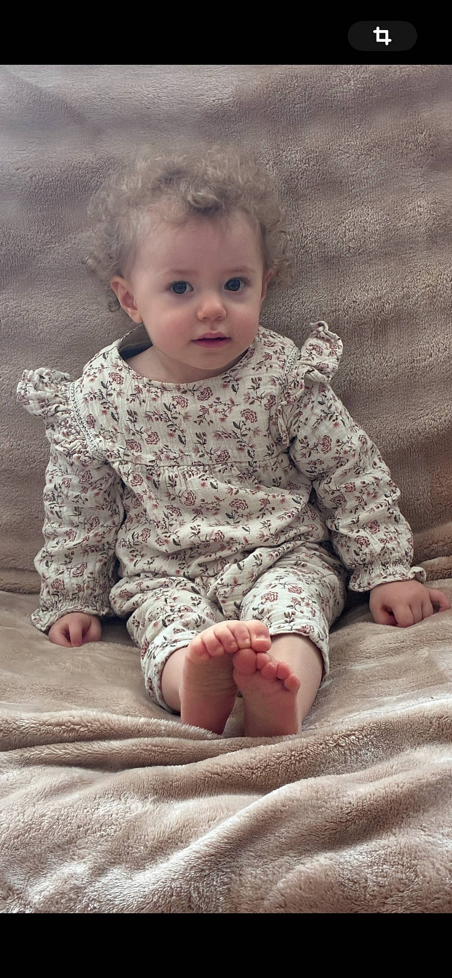 ankle, baby, bodypart, clothing, couch, face, finger, furniture, hand, happy, head, longsleeve, newborn, person, photography, portrait, sitting, sleeve, smile, toe