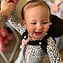 Belladonna June is registered to the contest to win money with this photo: baby, toddler, child, smile, happy, onesie, leopard_print, topknot, hair, tattoo, hand, grip, portrait, closeup, indoor, nursery, bokeh, playful, cheeks, expression