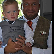 Lincoln joined the competition — help win amazing prizes! child, man, toddler, suit, vest, tie, formal_wear, portrait, indoor, holding, blue_eyes, short_hair, beard, smiling, person, fashion, family, event, closeup, hands